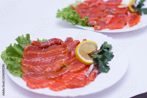 salmon with lemon on a white plate