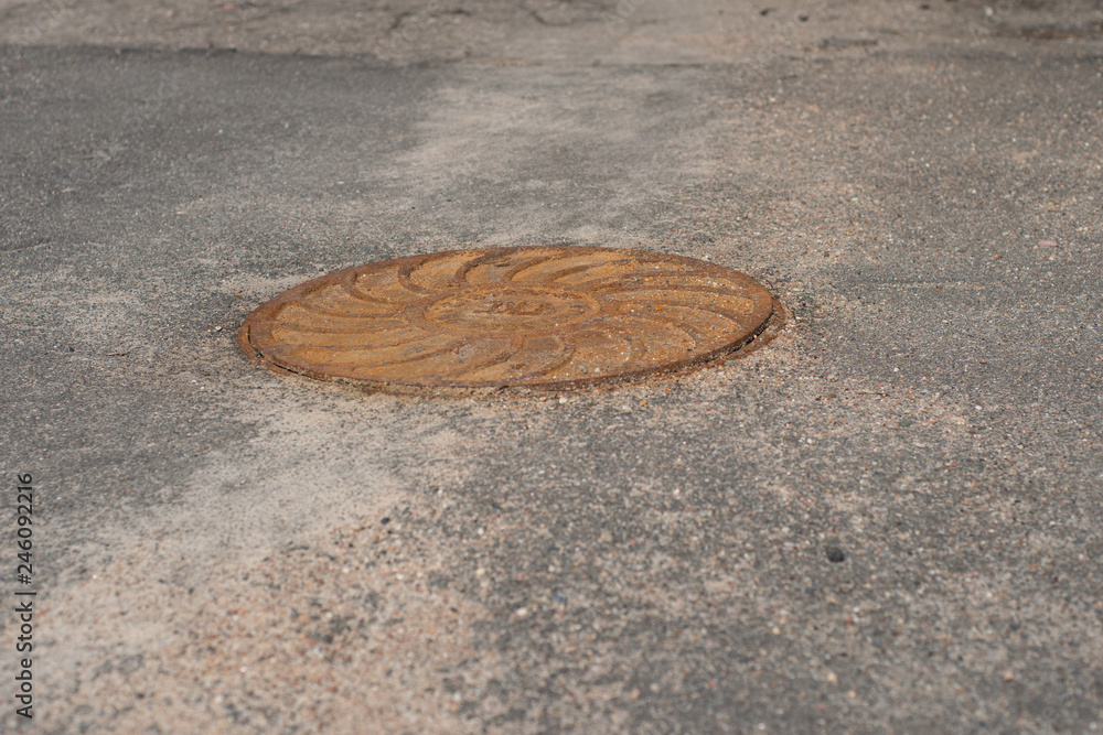 rusty sewer hatch on the road