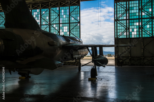 Fotografía American military bomber aircraft with bombs parked in airport base hangar ready