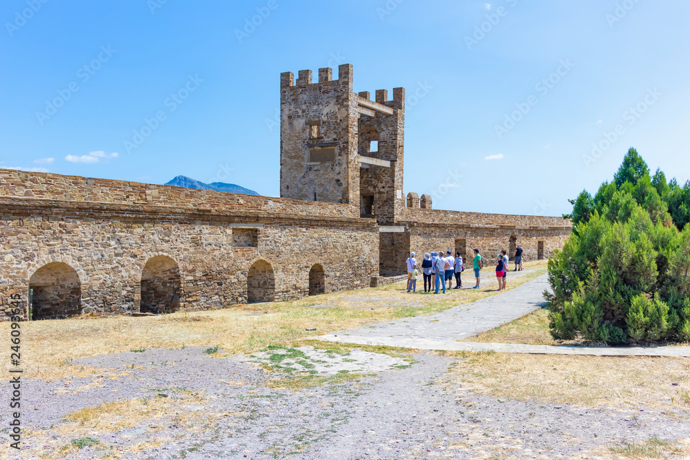 Obraz premium Genoese fortress in Sudak, Crimea. Tourists see the Pasquale Judiche tower.