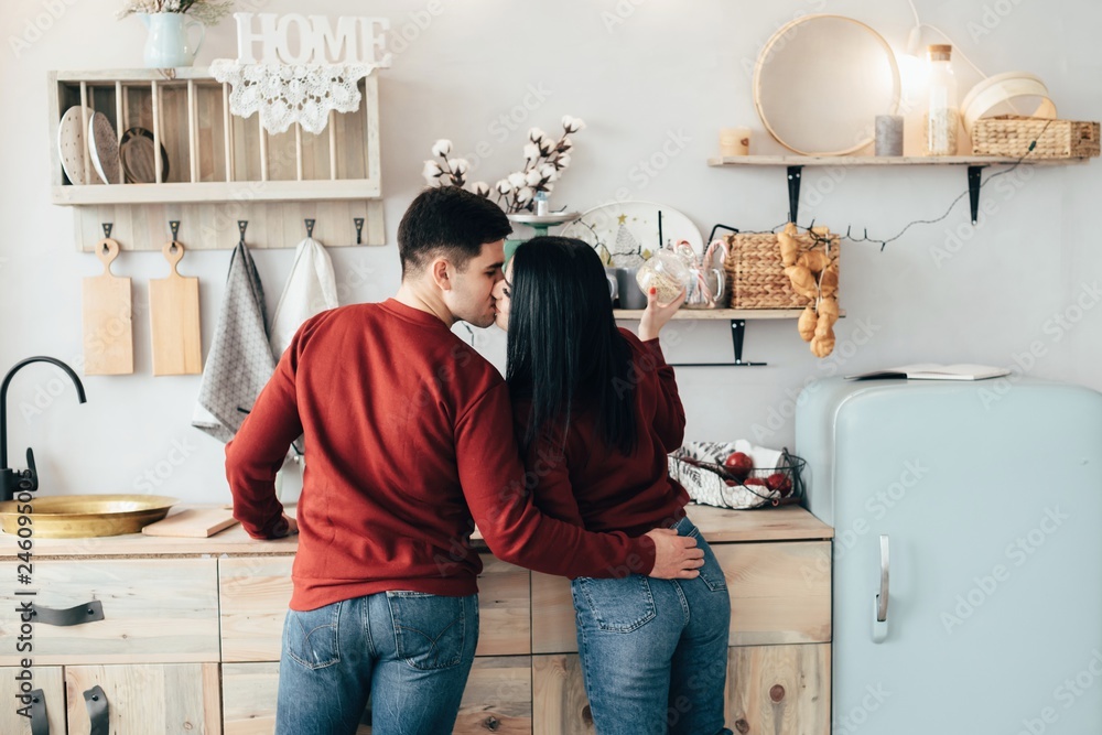 Man and woman hugging in a kitchen and have fun spending time Man and woman hugging in a kitchen and have fun spending time