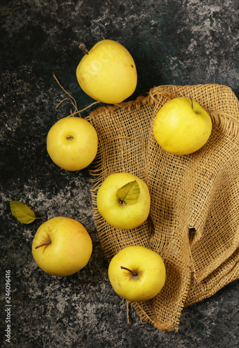 ripe yellow organic apples on a wooden table