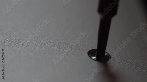 Macro view of screw being removed from a notebook photo