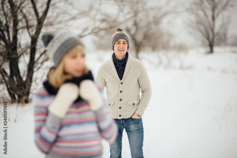 Happy Young Couple in Winter Park having fun.Family Outdoors. love