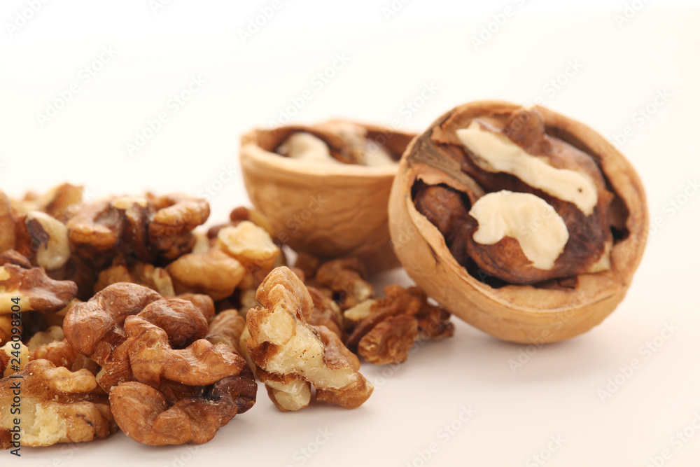 A pile of peeled walnuts at white background A pile of peeled walnuts at white background