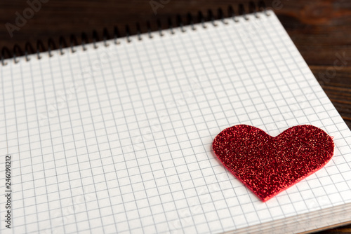 Notepad on dark wooden background.