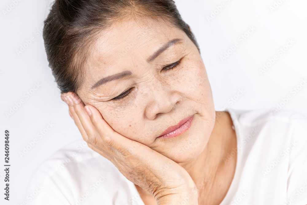 Old wrinkled asian woman thinking with copy space Old wrinkled asian woman thinking with copy space