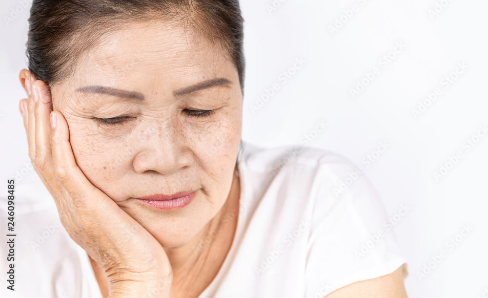 Old wrinkled asian woman thinking with copy space Old wrinkled asian woman thinking with copy space
