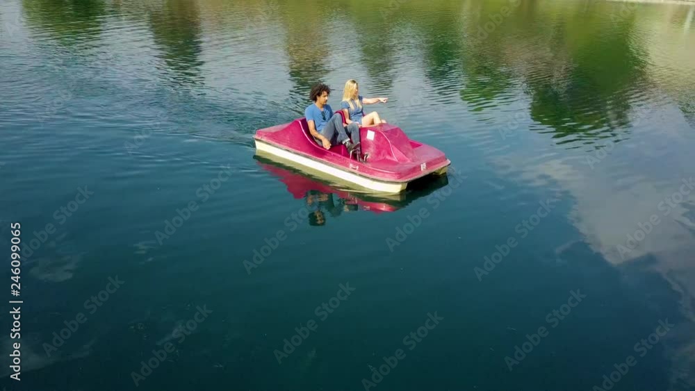 Cute couple enjoying a boat ride in the park. Cute couple enjoying a boat ride in the park.