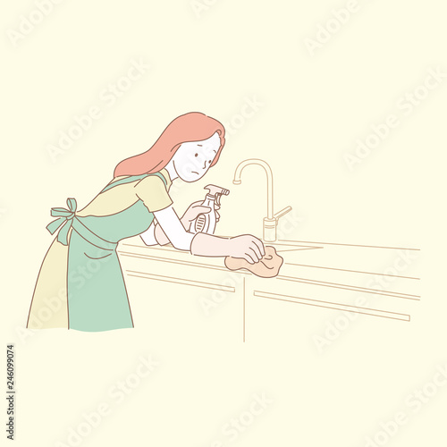 Woman cleaning kitchen countertop