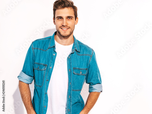 Portrait of handsome smiling stylish hipster lumbersexual businessman model dressed in jeans clothes. Fashion man isolated on white
