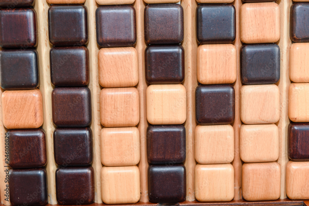 Children play a logic game with wooden cubes. Board game. Children play a logic game with wooden cubes. Board game.