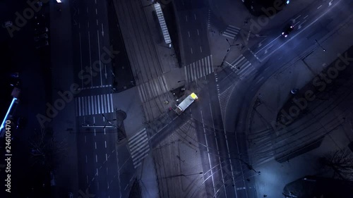 Aerial night vertical view Traffic cars on the intersection and street lights and illuminated streets in a modern city. Traffic. Drone