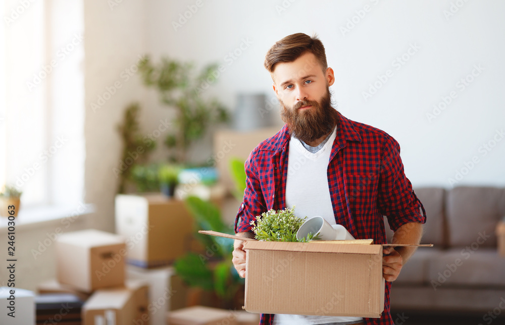 happy man with boxes moves to new apartment happy man with boxes moves to new apartment