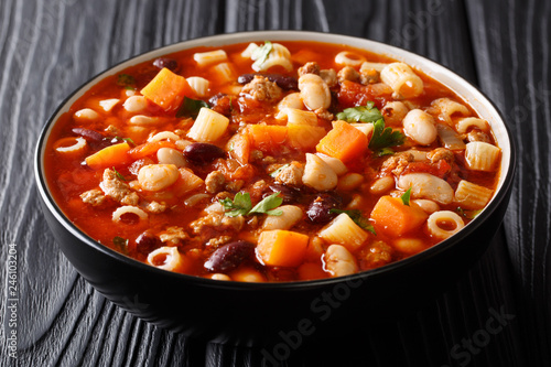 Traditional fagioli soup with vegetables, ditalini pasta and ground beef closeup in a bowl. horizontal