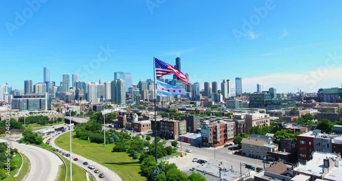 Aerial drone shot of Chicago downtown above the highway with american flag. USA Flag in the middle.