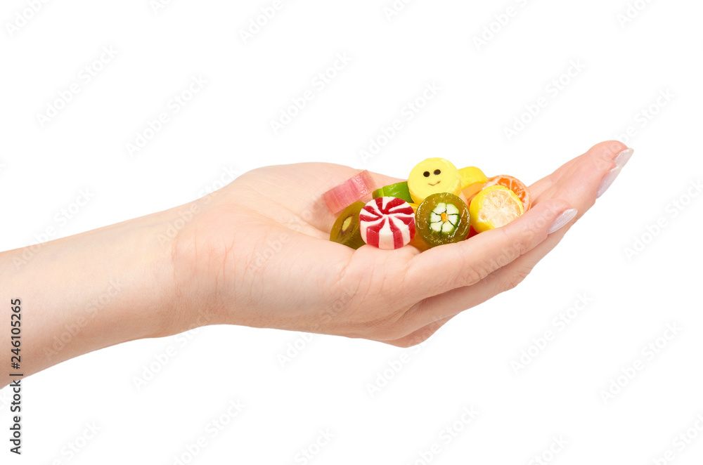 Hand with colored round candy, sugar lollipop Hand with colored round candy, sugar lollipop