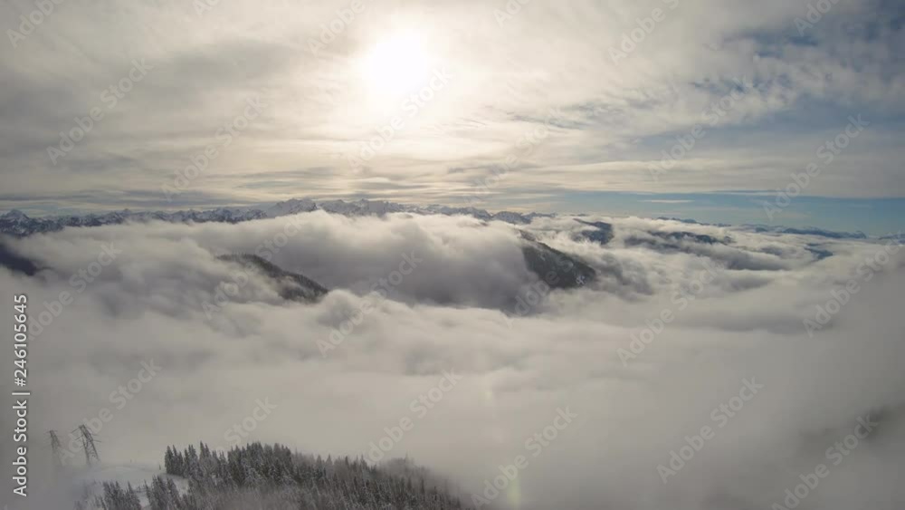 Aerial Flyback Over Mountain Ridge with Rolling Fog Over Winter Snow Aerial Flyback Over Mountain Ridge with Rolling Fog Over Winter Snow