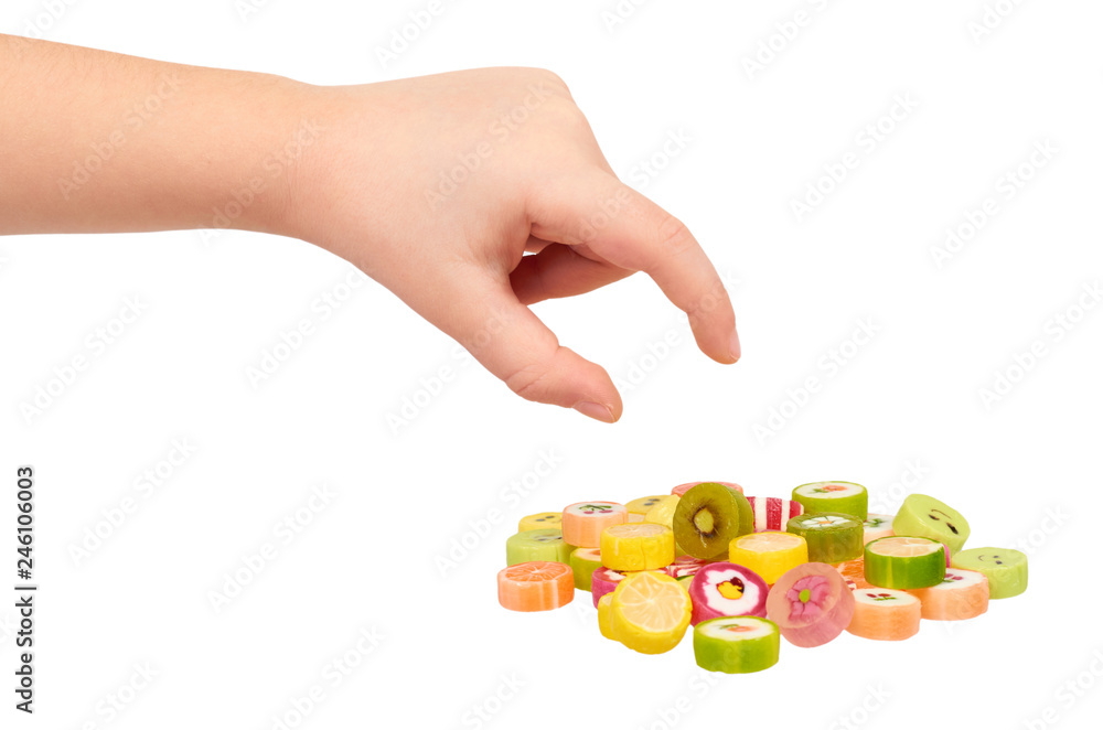 Kids hand with colored round candy, sugar lollipop Kids hand with colored round candy, sugar lollipop