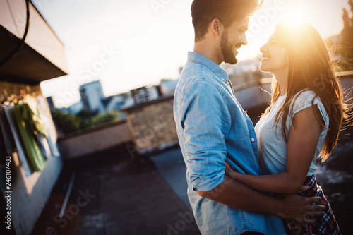 Couple in love enjoying in sunset in a terrace