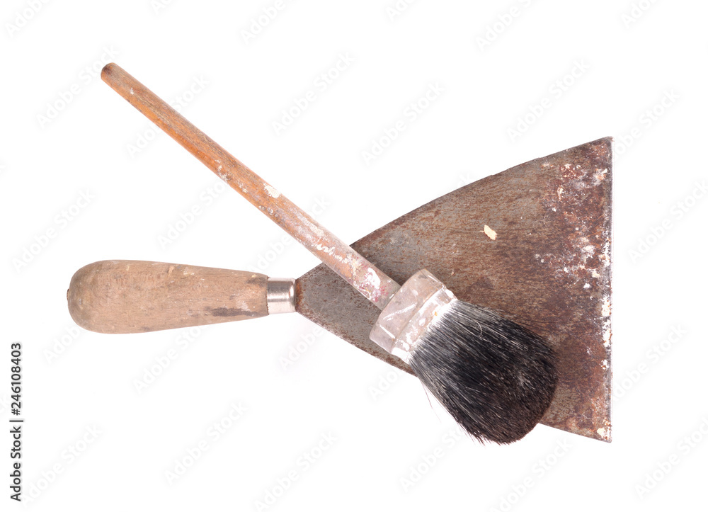 Old paintbrush with a putty knife