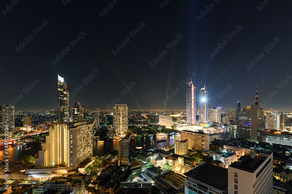 Golden light buildings in downtown with Chao Phraya river in New Year festive at Bangkok