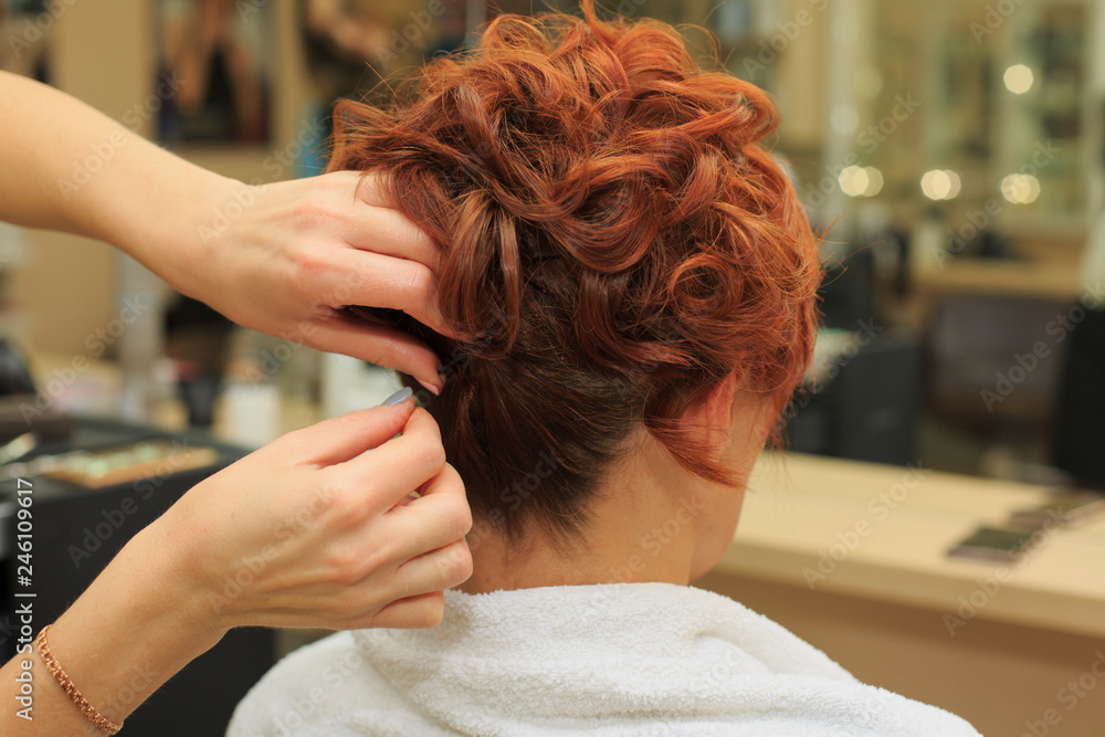 Fototapeta premium Hairdresser makes beautifull hairstyle at the salon