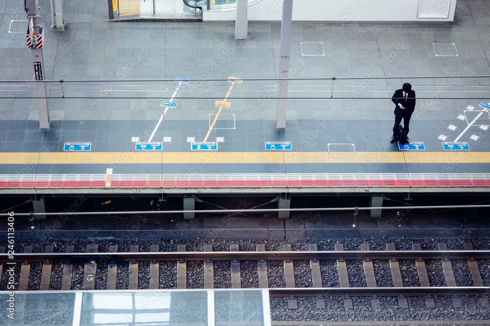 Man stand on train station platform Asian Business people using mobile phone Japan city lifestyle Man stand on train station platform Asian Business people using mobile phone Japan city lifestyle
