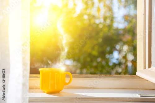 Good morning! Cup on the window with sun photo