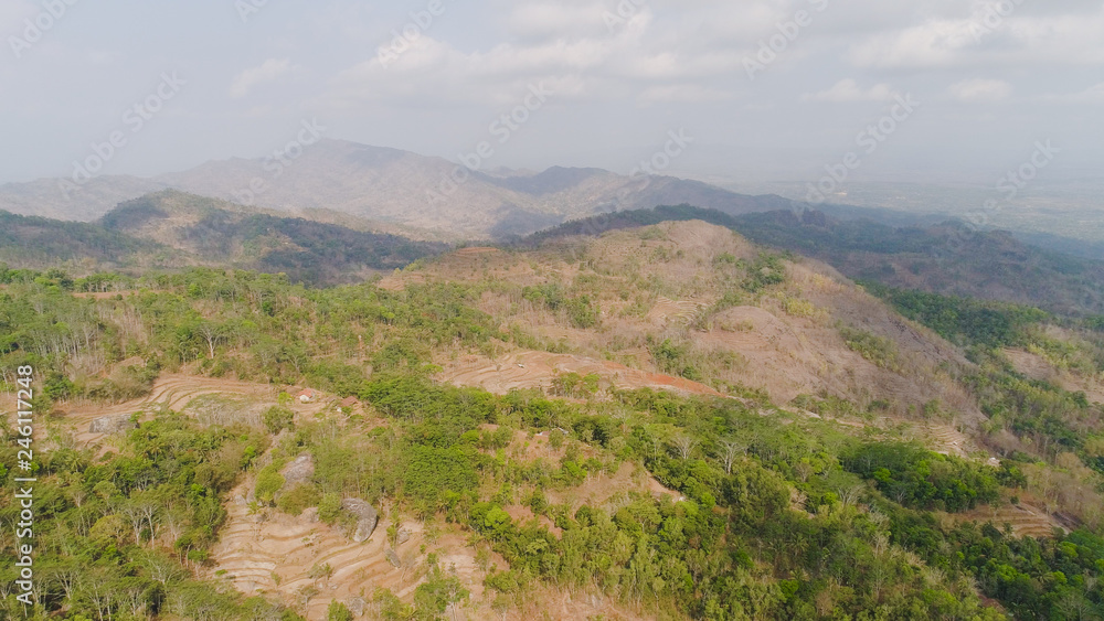 mountain landscape high cliffs mountains covered with green tropical forest. aerial view mountain forest with large trees and green grass. tropical landscape in asia Jawa, Indonesia