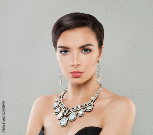 Elegant woman with short hairdo, makeup, luxurious diamond necklace and earrings portrait