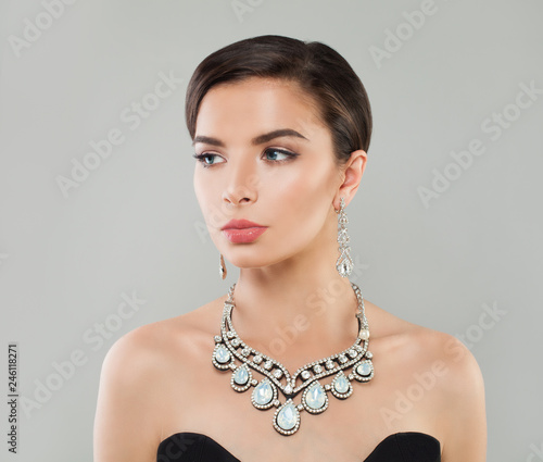 Stylish woman with short hair, makeup and diamond jewelry, fashion portrait