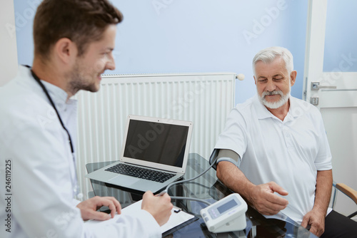 Doctor and elderly man during consultation.