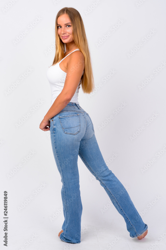 Full body shot of happy young beautiful blonde woman looking back Stock ...