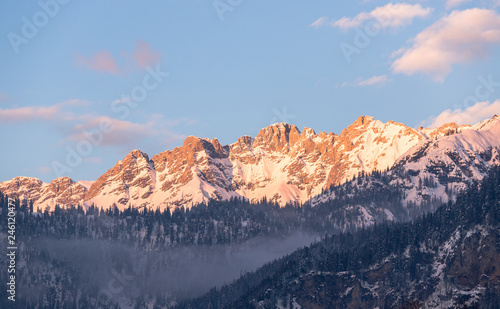 Idyllic snowy mountain peaks, setting sun in winter, landscape, Alps, Austria