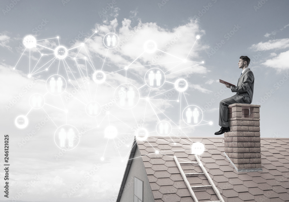 Man on roof reading book and concept of social connection Man on roof reading book and concept of social connection