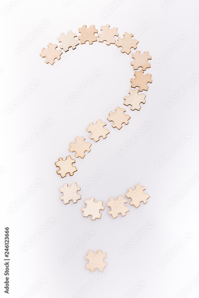 Naklejka premium Question mark made from puzzle pieces on white background