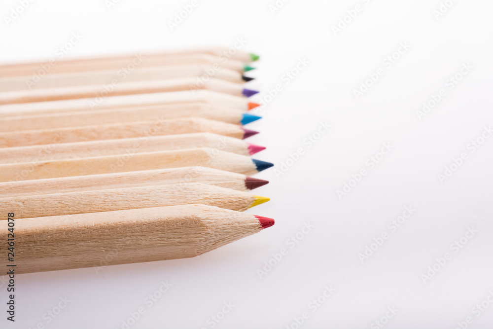Obraz premium Colorful pencils in a row on white background