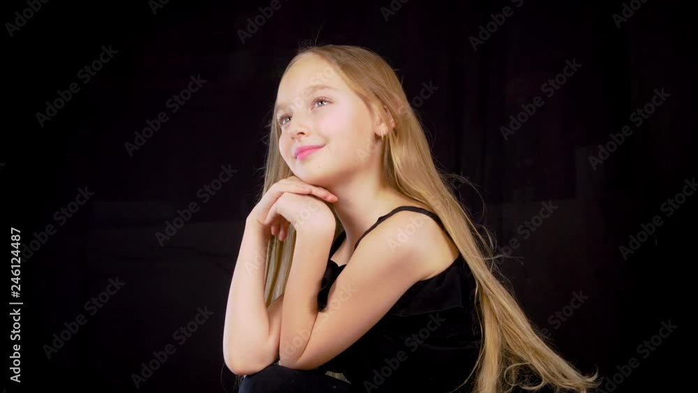Portrait beautiful girl with long hair waving in wind on black ...