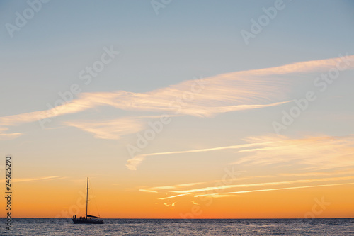 Lonely boat floats on a quiet warm calm sea © Rithor
