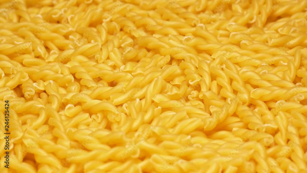 UHD closeup shot of the dry Gemelli pasta on a rotating stand UHD closeup shot of the dry Gemelli pasta on a rotating stand