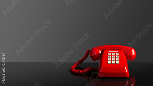 Red old vintage telephone on black background