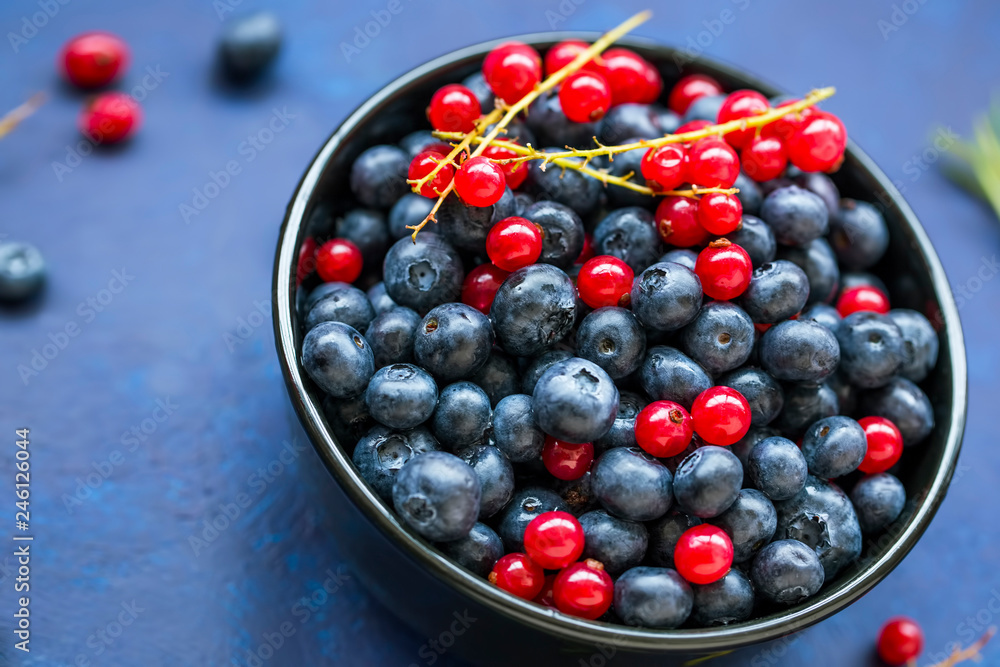 Bowl of healthy organic berries with blueberries and red currants Bowl of healthy organic berries with blueberries and red currants
