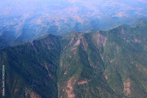 Beautiful of green mountaind looks from the window of the plane. photo