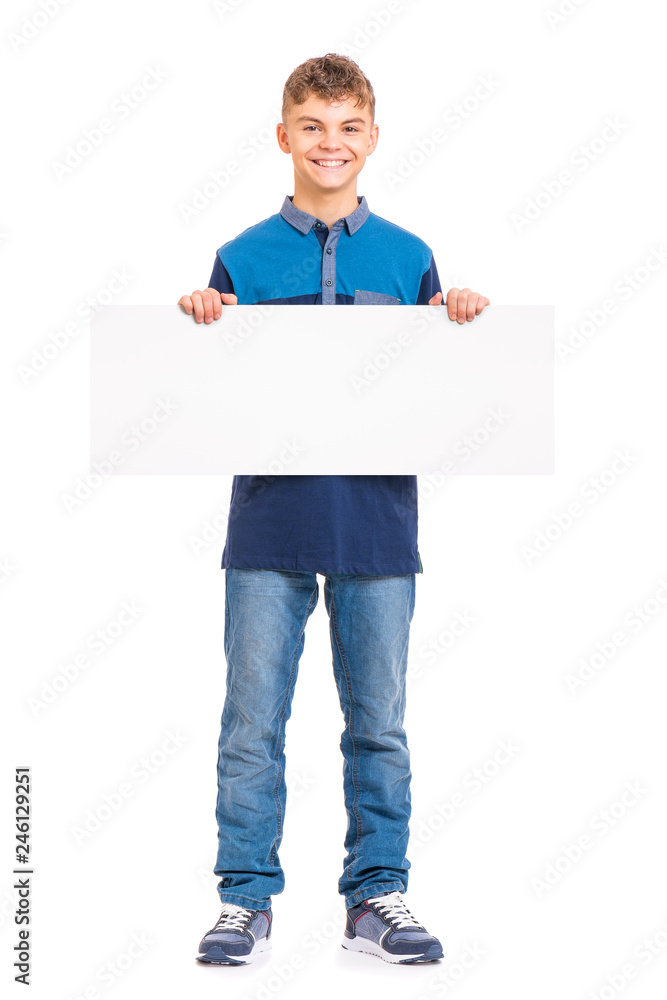 Full length portrait of young caucasian teen boy holding white board. Funny teenager showing empty billboard sign and looking at camera, isolated on white background. Full length portrait of young caucasian teen boy holding white board. Funny teenager showing empty billboard sign and looking at camera, isolated on white background.