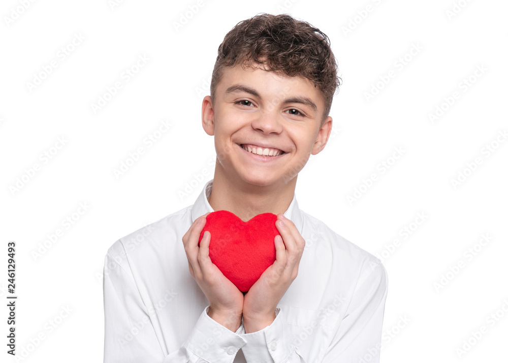 Happy Valentines Day. Cute young Teen Boy in Love with Red plush Heart in his hands. Smiling Child looking at camera, isolated on white background. Happy Valentines Day. Cute young Teen Boy in Love with Red plush Heart in his hands. Smiling Child looking at camera, isolated on white background.