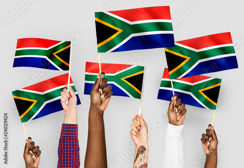 Hands waving flags of South Africa