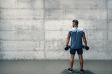 Man holding dumbbells while standing with backs turned. If it was easy, everyone would do it.