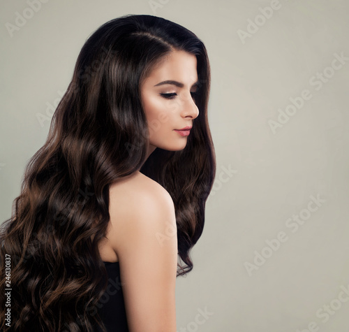 Healthy hair woman. Nice girl with brown curly hair. Hair care concept