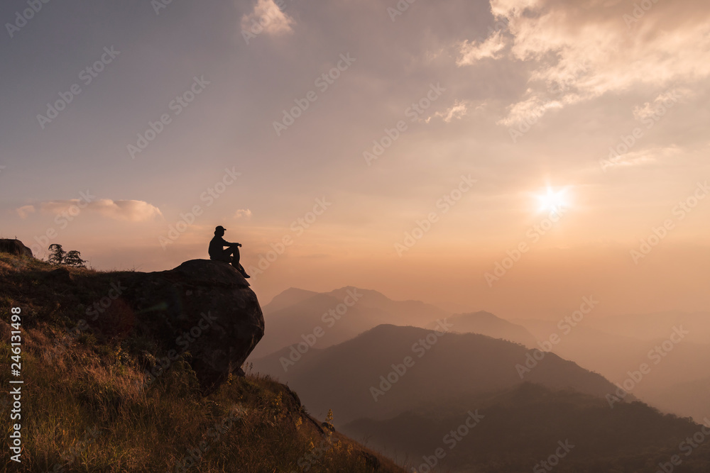Young traveler relaxing and looking beautiful landscape on top of mountain, Adventure travel lifestyle concept